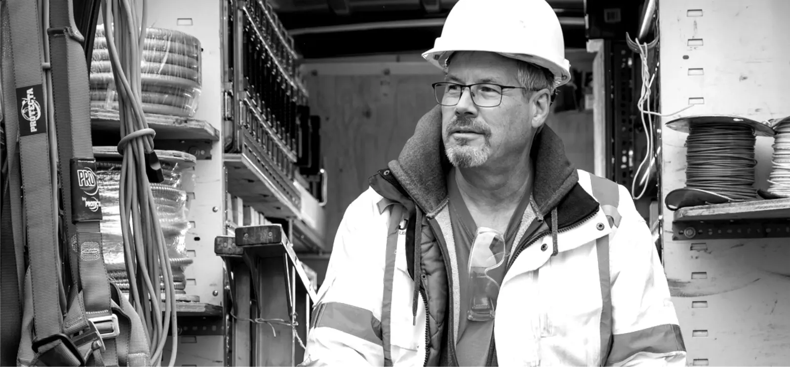 man with glasses in hardhat smiling
